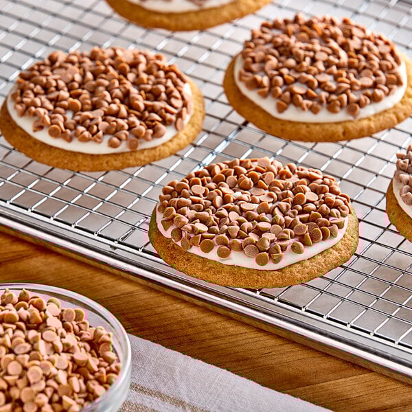 A cookie with white frosting and Simply Natural Caramel baking chips on top.
