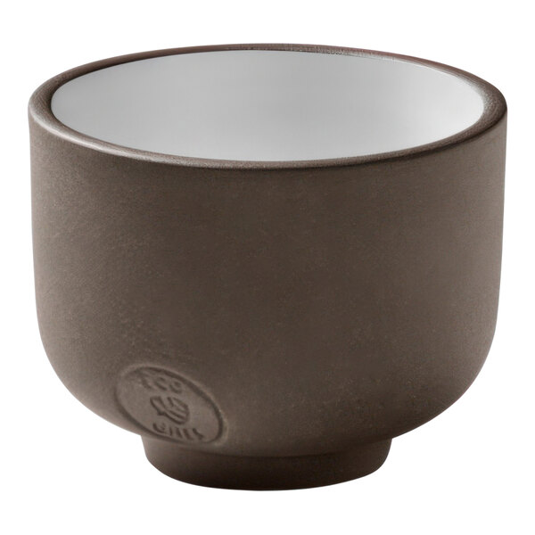 A brown ceramic Playground ReNew cup with a white rim.