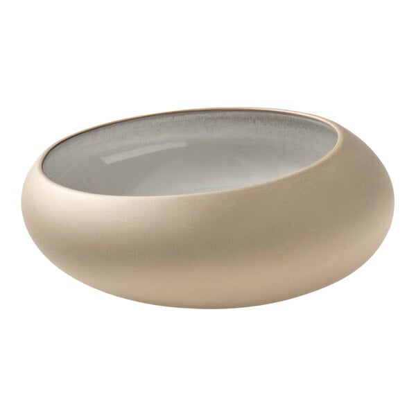 A close up of a white Playground Embrace Eco-Gres bowl with a clear rim.