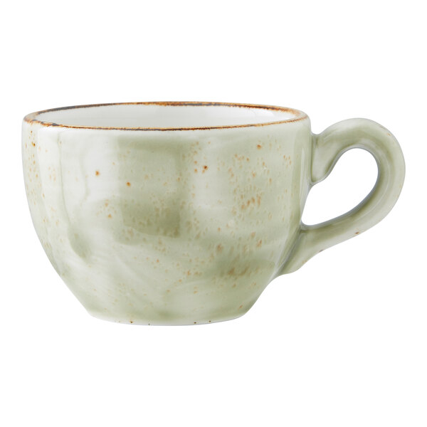 A small green ceramic cup with a handle.