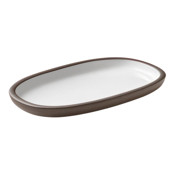 A white oval plate with brown rim.