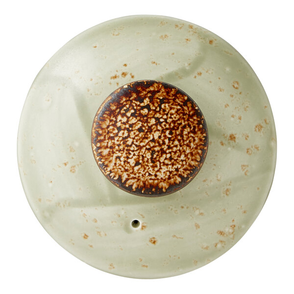 A ceramic lid for a 15 oz. green club teapot with a speckled design and a central brown knob.