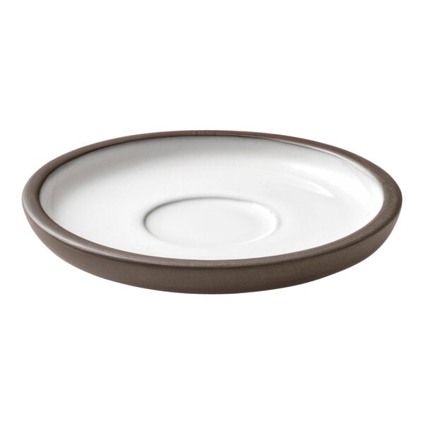 A white Playground ReNew saucer with a brown rim.