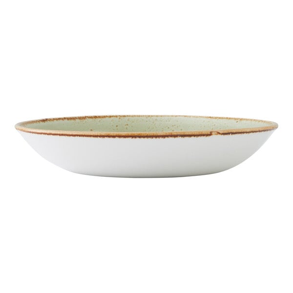 A round, shallow green coupe bowl with a rustic brown rim.