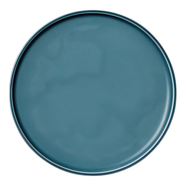 A close-up of a Schonwald Petrol Blue porcelain coupe plate with a rim.