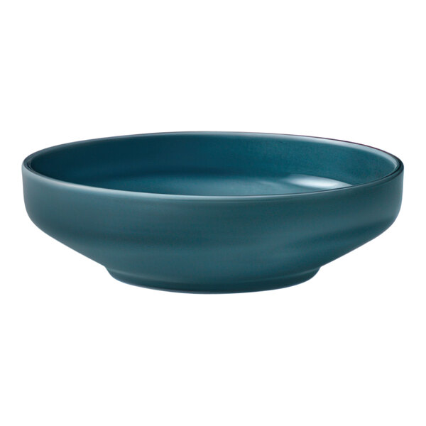 A Schonwald Petrol Blue coupe bowl with a white background and dark blue rim.