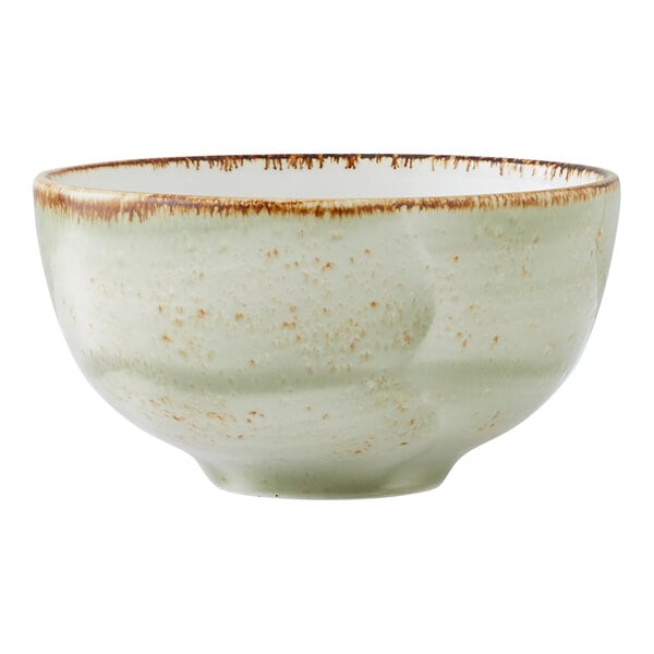 A green ceramic bowl with a speckled finish and a slightly rustic brown rim.
