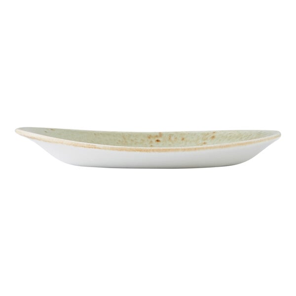 A small, oval-shaped green ceramic plate with a slightly irregular edge.