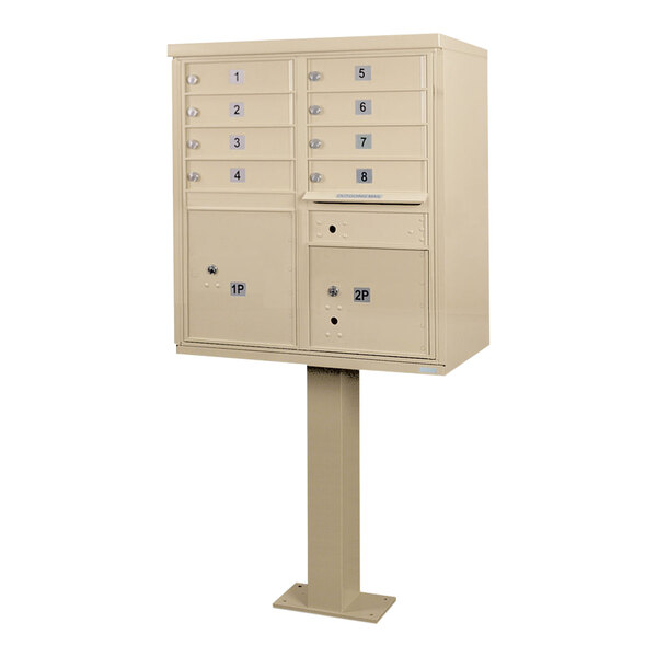 A sandstone pedestal cluster mailbox with 8 doors and numbers on it.