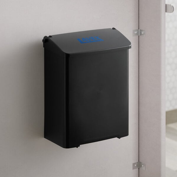 A Lavex black plastic wall-mount sanitary napkin receptacle on a wall.