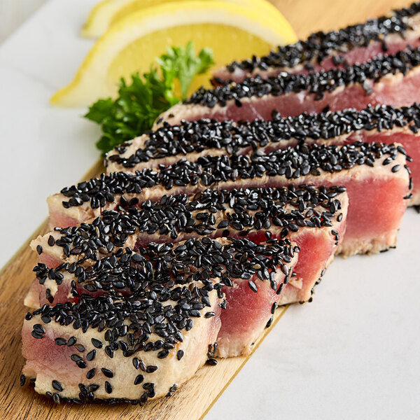 Sliced tuna with black sesame seeds on top.
