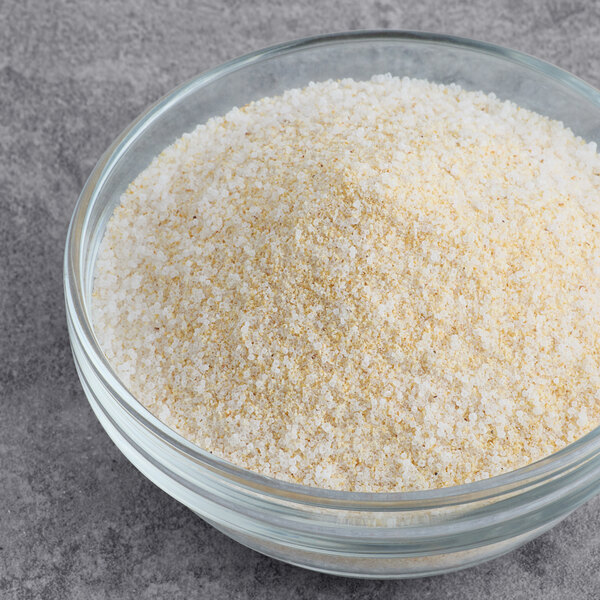 A bowl of white and yellow salt with Hometown Provisions Garlic Salt.