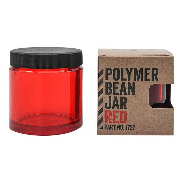 A red plastic Comandante bean jar with a black lid.