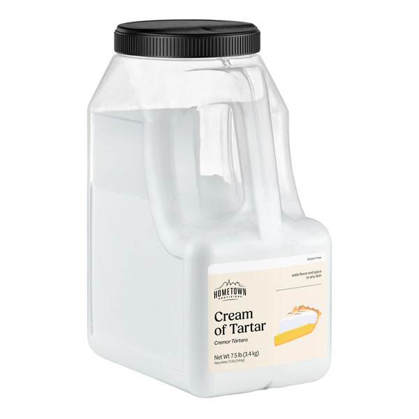 A large clear plastic container with a black screw-on lid, labeled 'Cream of Tartar' and featuring an image of a pie slice on the front.