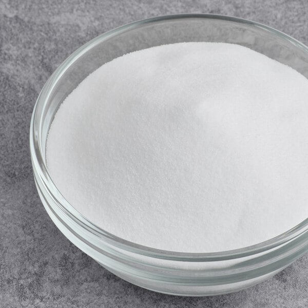 A bowl of Hometown Provisions Fine Sea Salt on a grey surface.