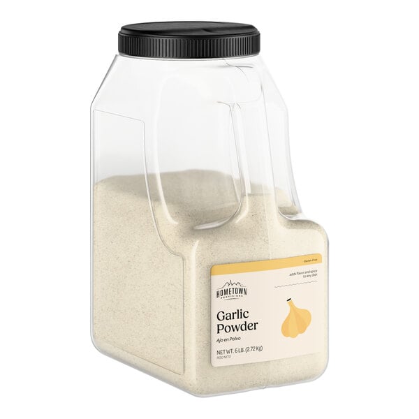 A large plastic container of Hometown Provisions garlic powder weighing 6 pounds.