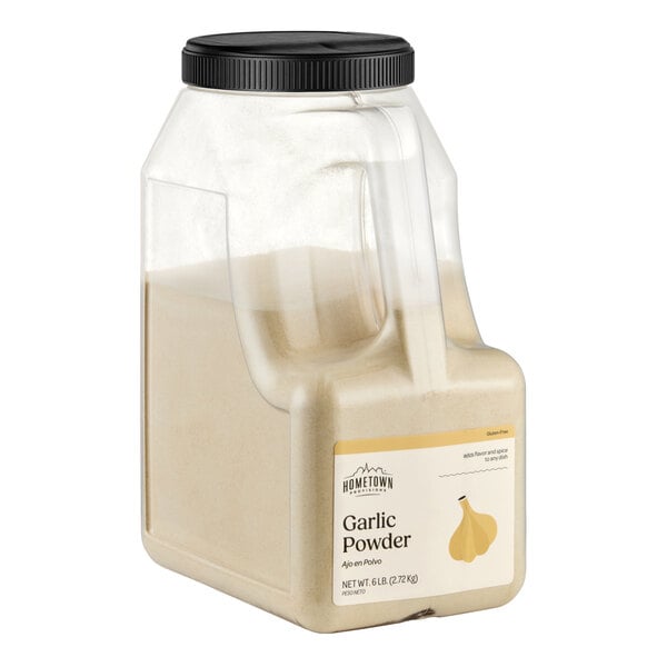 A large clear plastic container with a black lid, filled with light beige garlic powder and labeled on the front.