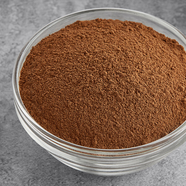 A bowl of brown Hometown Provisions Ground Allspice powder.