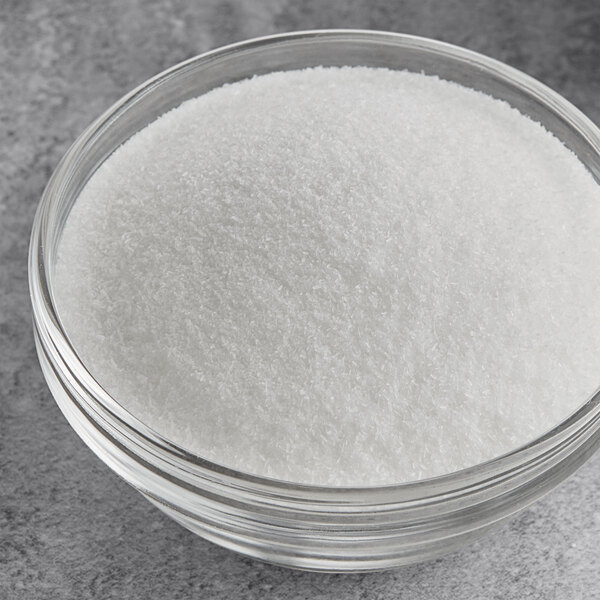 A bowl of Hometown Provisions MSG powder on a table.