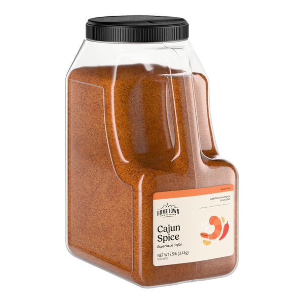 A large plastic container of Hometown Provisions Cajun Spice.