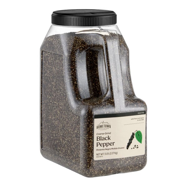 A large clear plastic container with a black screw-on lid, filled with coarse ground black pepper and labeled on the front.