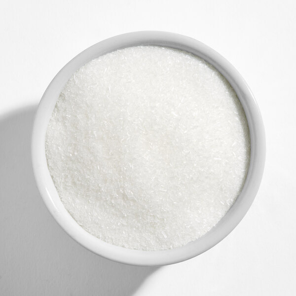 A white bowl filled with MSG powder.