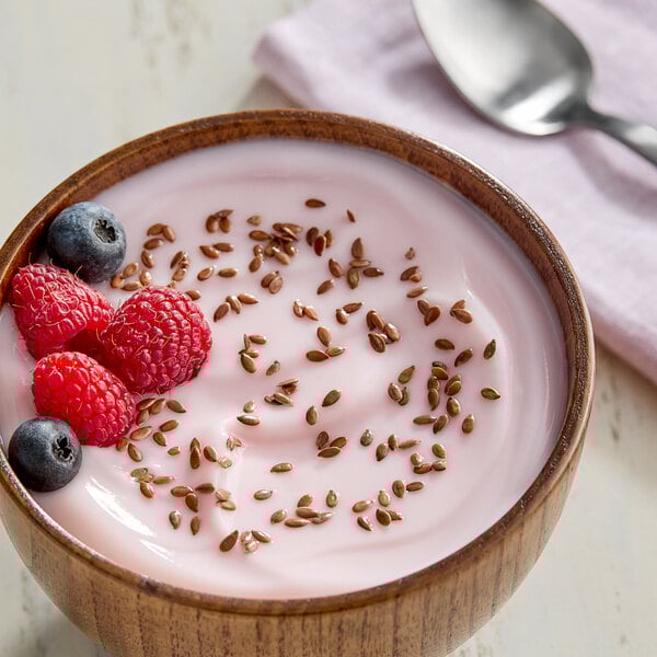 A bowl of yogurt with blueberries and flax seeds.