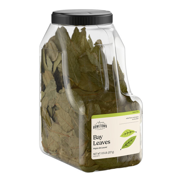 A large plastic container of dried bay leaves labeled as Hometown Provisions Bay Leaves, 0.5 lb.