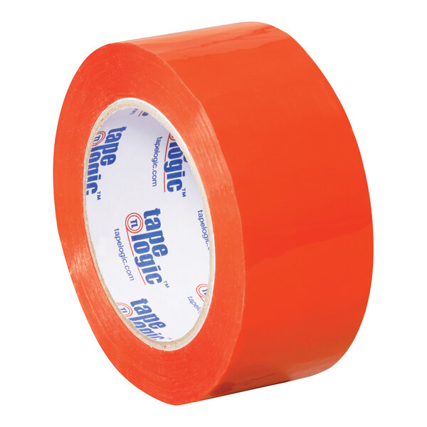 A close-up of a roll of Tape Logic orange carton sealing tape with white writing on it.