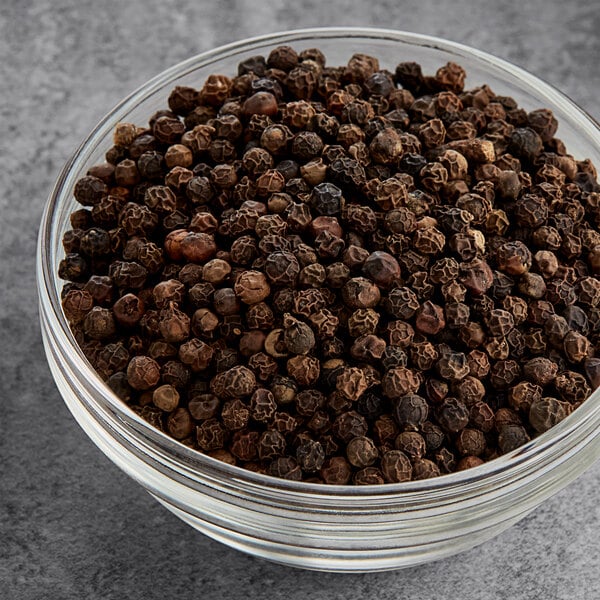 A bowl of Hometown Provisions whole black peppercorns.