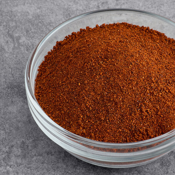 A bowl of Hometown Provisions chili powder on a gray surface.