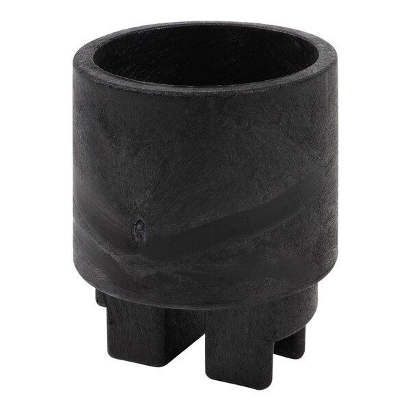 A black cylinder with a hole on three legs.