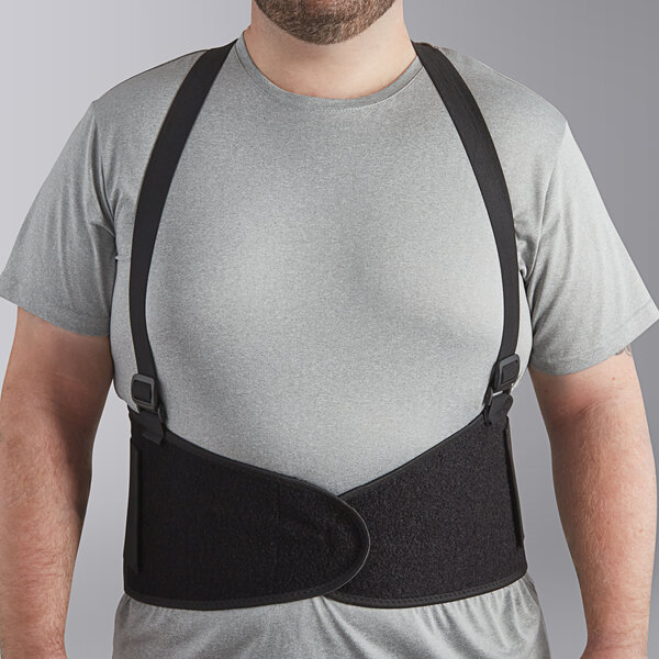 A man wearing a Lavex black back support belt with a grey shirt.