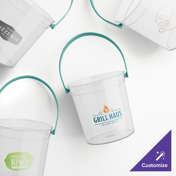 A close-up of a clear Howw Manufacturing plastic drink bucket with teal handles.