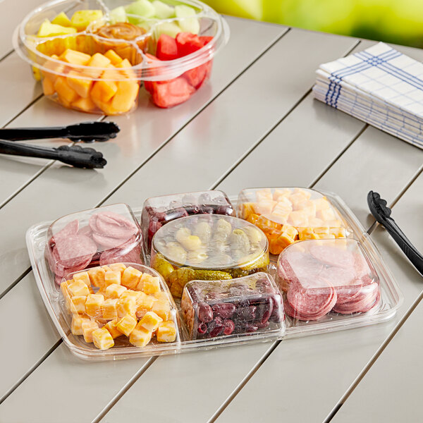 An Inline Plastics rectangular plastic tray with assorted fruit and vegetables in it.