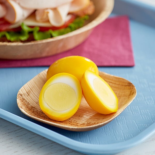 A plate with two Martin's hard boiled eggs and a sandwich.