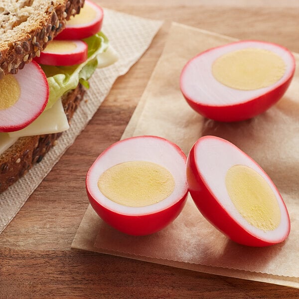 A sandwich with eggs cut in half on white bread.