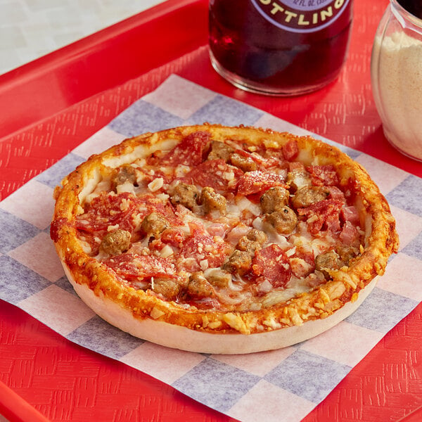 A Red Baron Deep Dish Meat Trio pizza on a red tray.