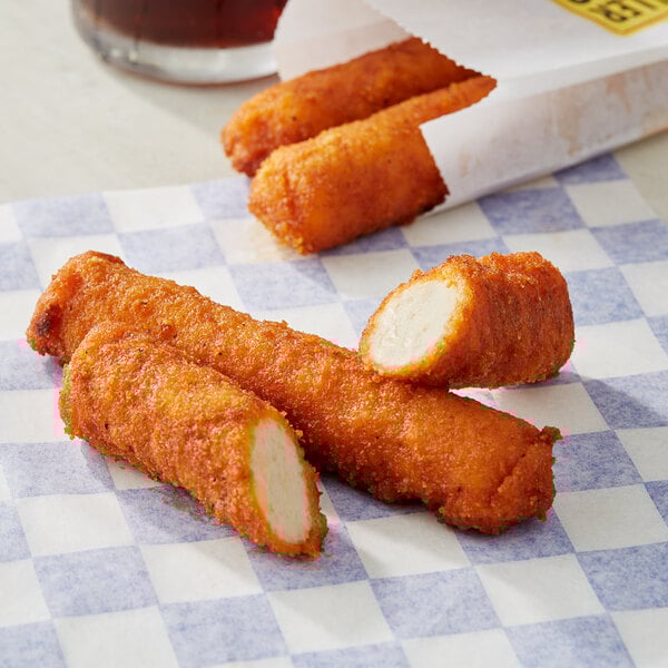 A close up of RollerBites Buffalo Ranch Chicken Sticks on a plate.