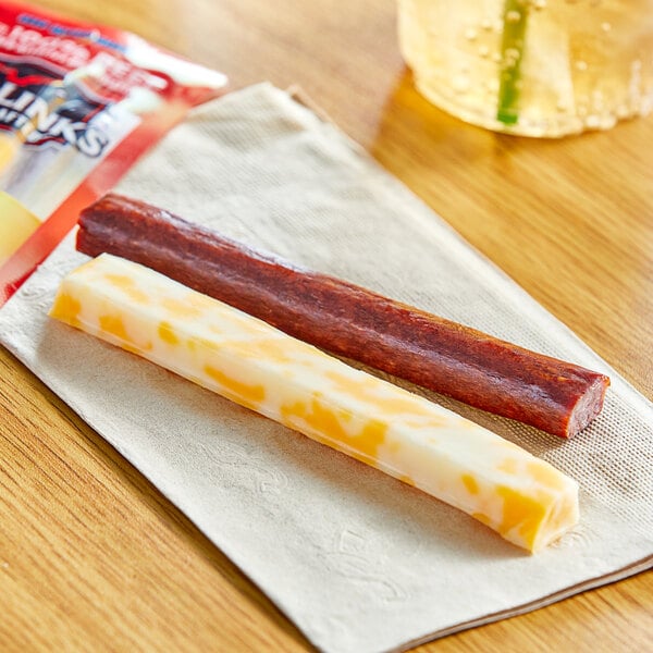 A Jack Link's Colby Jack cheese stick and beef stick on a napkin.