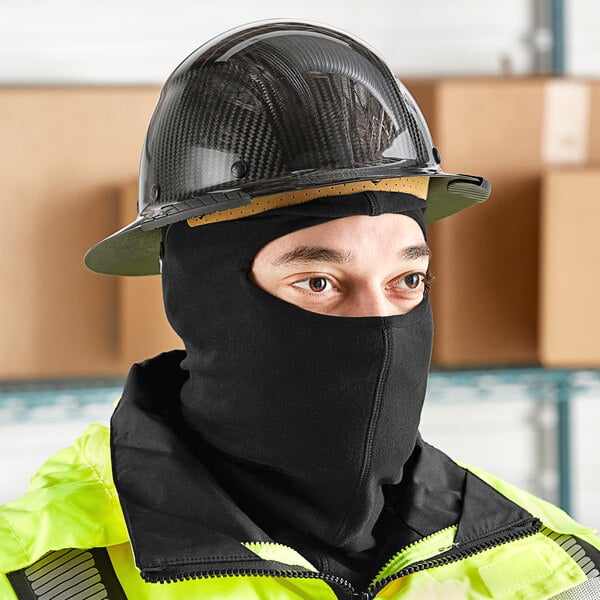 A man wearing a black Lavex fleece balaclava face mask and a hard hat.