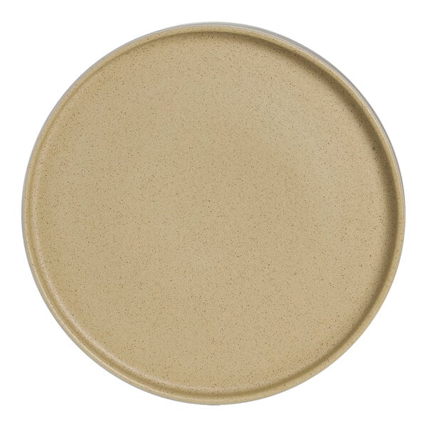 An Anfora Crete round beige china plate with a small hole in the middle.