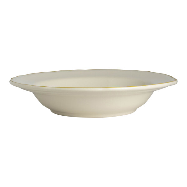 A white bowl with a yellow rim and gold trim.