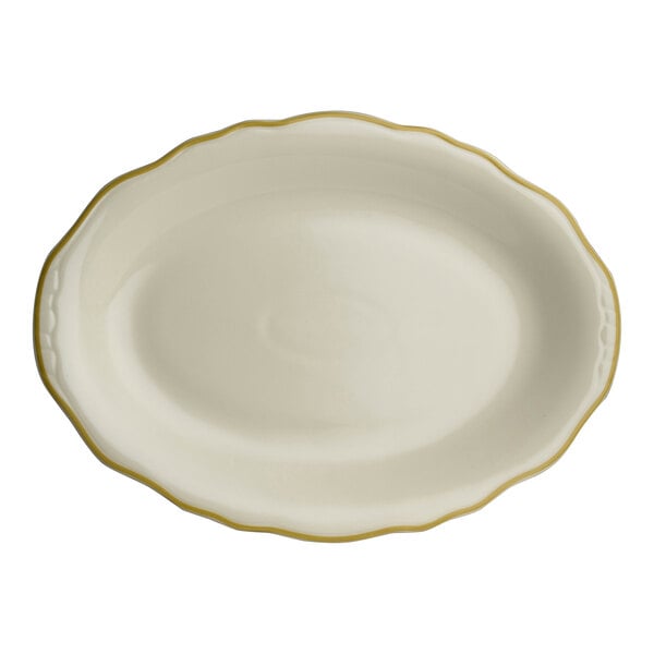 A white oval china platter with scalloped edges and gold trim.