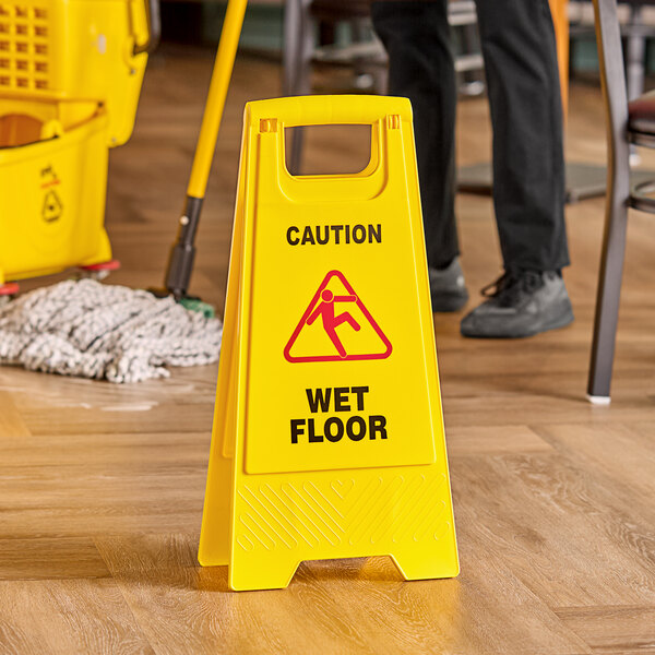 An Advantage Supplies yellow plastic caution wet floor sign.