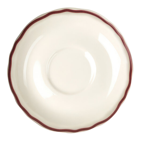 A close-up of a Homer Laughlin Maroon Scalloped China Saucer with a small red rim.