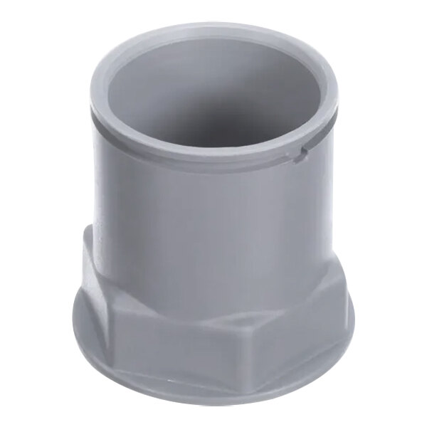 A grey plastic pipe fitting with white text on it.