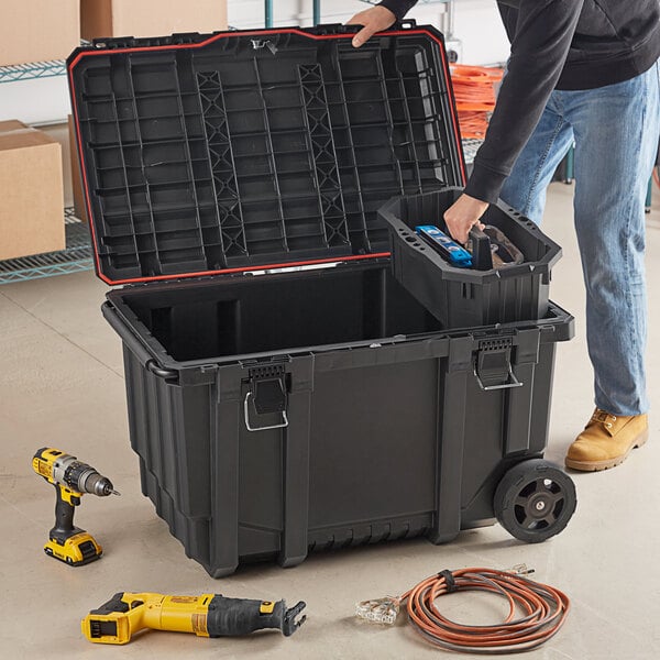 A person opening a Tough Box rolling tool chest.