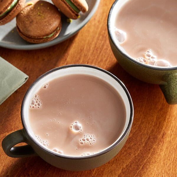 Two cups of Cocoa Classics mint and chocolate hot chocolate on a table.
