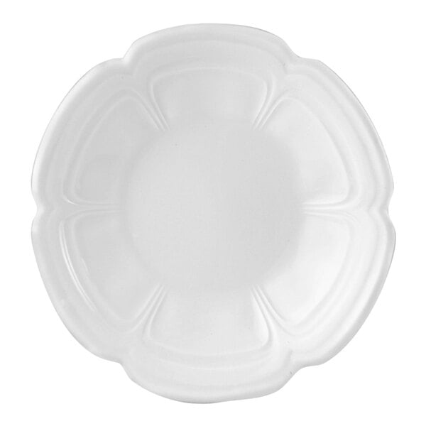 A close-up of a Steelite white scalloped oatmeal bowl with a flower design.